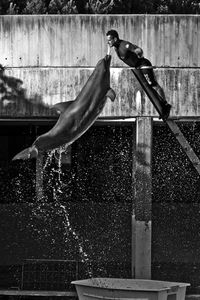 Reflection of man jumping on water