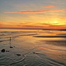 Scenic view of beach against sky during sunset