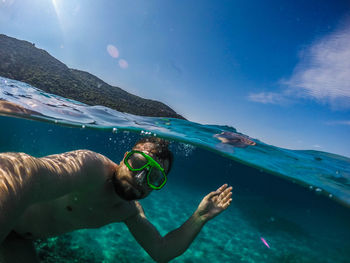 Close-up of young man swimming in sea