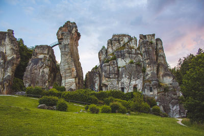 Low angle view of rock formations against sky