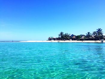 Scenic view of sea against clear blue sky