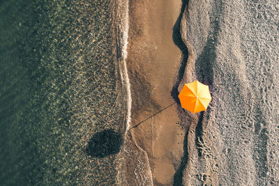 Beach umbrella on white sand