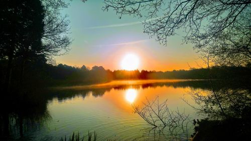 Scenic view of lake against sky during sunset