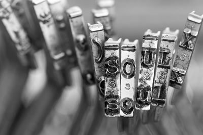 Close-up of padlocks hanging on metal for sale