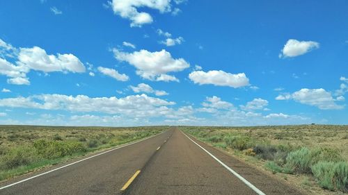 Empty road along countryside landscape