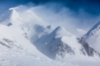 Scenic view of mountains against sky during winter