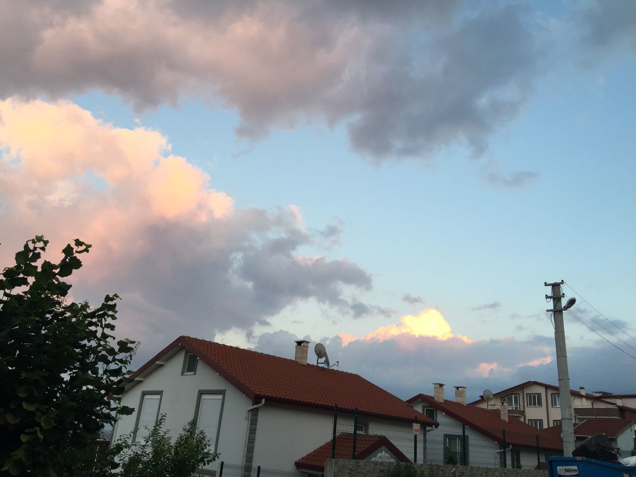 building exterior, architecture, built structure, sky, house, cloud - sky, residential structure, low angle view, residential building, roof, cloudy, cloud, high section, building, outdoors, town, sunset, no people, nature, day