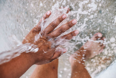 Close-up of person hand holding wet water