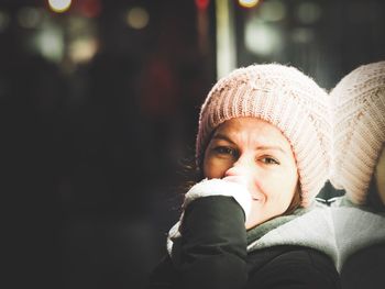 Close-up portrait of smiling mid adult woman at night