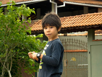 Portrait of boy standing outdoors