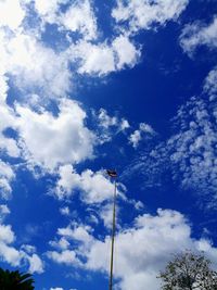 Low angle view of flag against blue sky