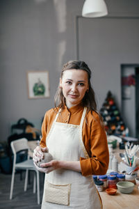 Portrait of a beautiful smiling pottery workshop leader