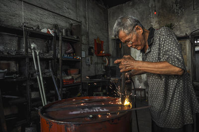 Man working on metal grate