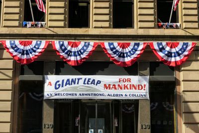 Low angle view of flags hanging on building