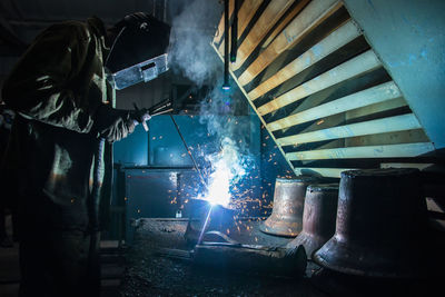 Man working on metal in factory