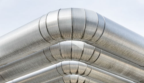 Low angle view of pipe on roof against sky