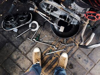 Low section of man wearing shoes standing at garage