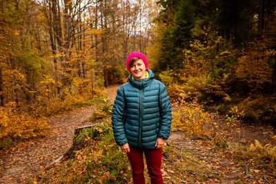 Portrait of a woman standing in forest