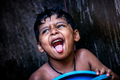 Portrait of shirtless boy in water