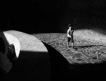 Boy standing on floor at night