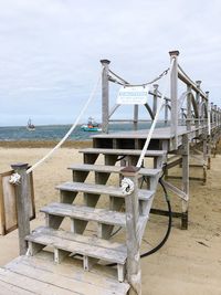 Lifeguard hut on beach against sky