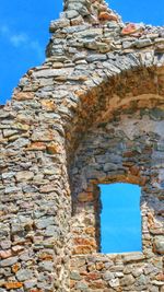 Low angle view of old ruins against sky