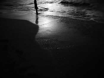 Low section of silhouette person on beach