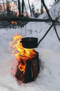 Campfire on snow covered landscape