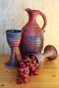 Close-up of fruits and vase on table