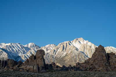 Scenic view of snowcapped mountains against clear blue sky