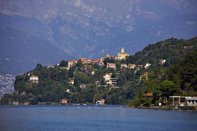 Village on mountain slope at lake