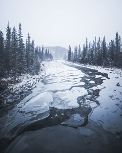 Scenic view of frozen lake against clear sky during winter