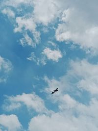 Low angle view of airplane flying in sky