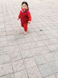 Full length of girl standing on footpath