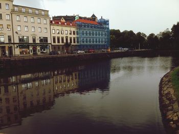 Bridge over river with buildings in background