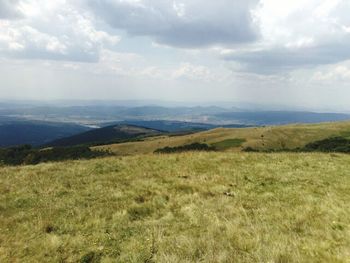 Scenic view of mountains against cloudy sky