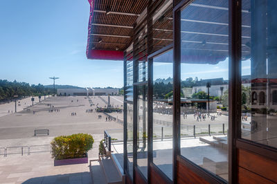 Buildings against sky seen through glass window
