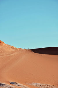 View of desert against clear blue sky