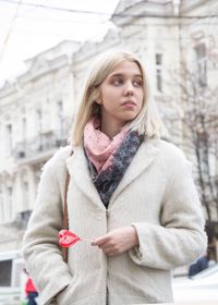 Portrait of beautiful woman standing in city
