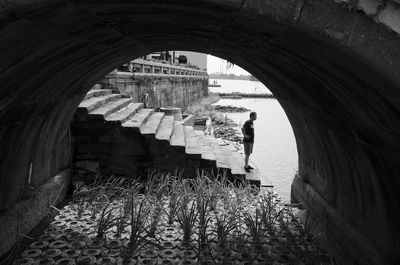 Woman walking on footbridge