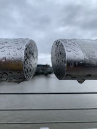 Close-up of raindrops on railing