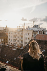 Rear view of woman looking at city buildings