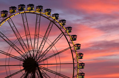 Low angle view of ferris wheel against sky