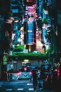 Cars on illuminated city street at night