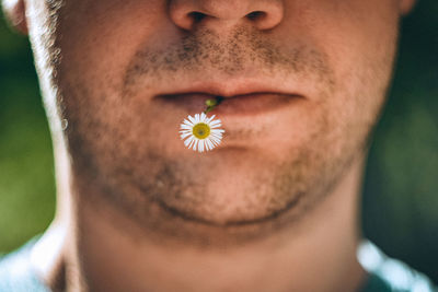 Close-up portrait of woman with red flower