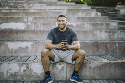 Portrait of smiling man sitting on steps