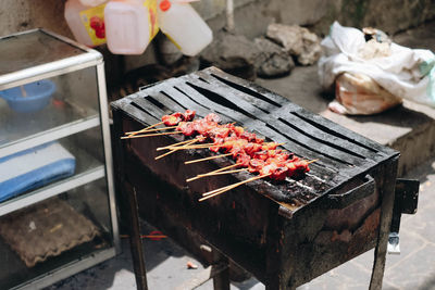 High angle view of meat on barbecue grill