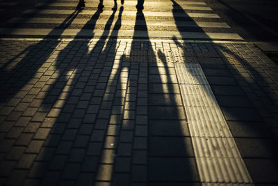 Shadow of people on footpath