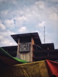 Low angle view of building against cloudy sky