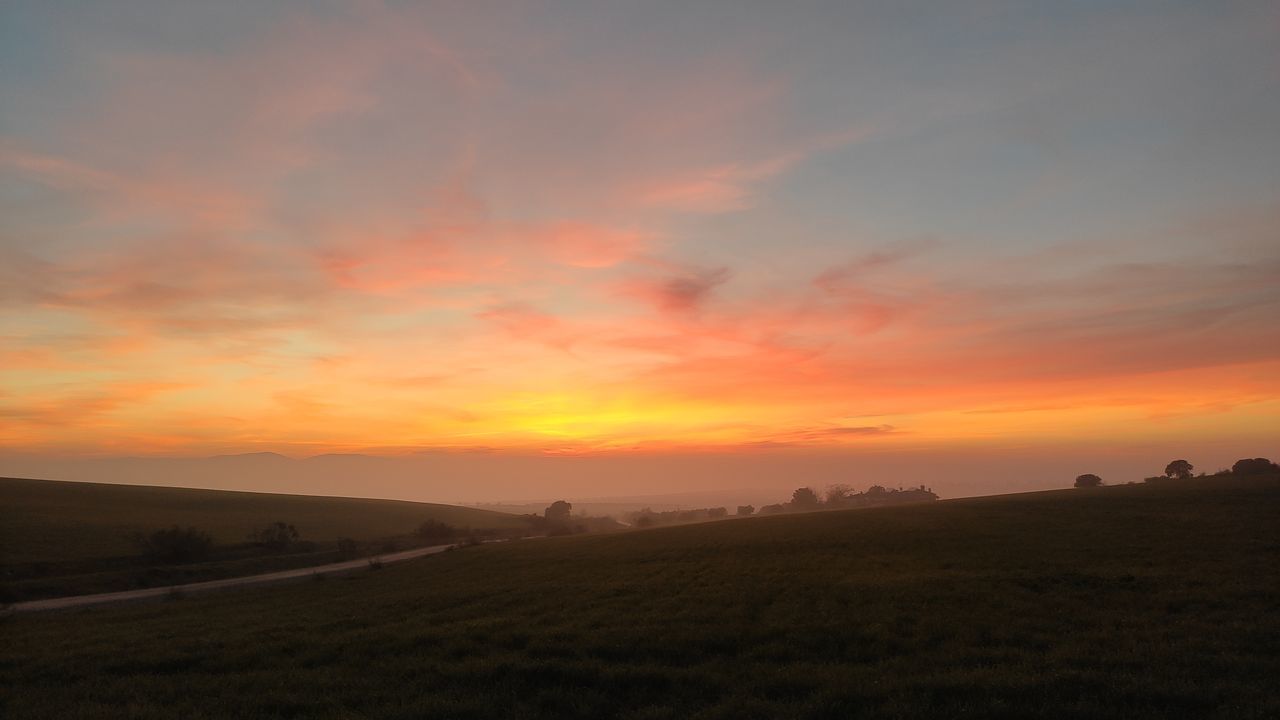 sky, sunset, landscape, environment, scenics - nature, beauty in nature, cloud, horizon, tranquility, tranquil scene, nature, land, field, dawn, orange color, silhouette, idyllic, afterglow, no people, rural scene, plain, non-urban scene, agriculture, dramatic sky, evening, hill, sun, outdoors, plant, sunlight, horizon over land, red sky at morning, grass, farm, prairie, twilight, travel